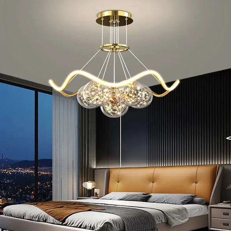 Modern gold bubble pendant chandelier with curved metallic arms and three glass globe shades for dining room decorbites bubble pendant