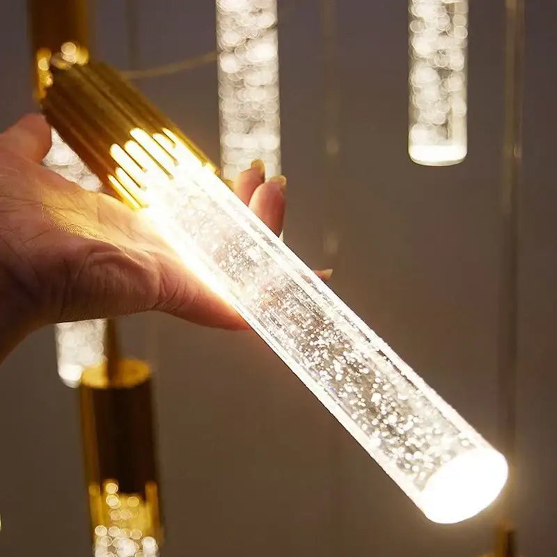 A glowing modern gold bubbles crystal pendant light with a bubble-filled acrylic body for living room decor