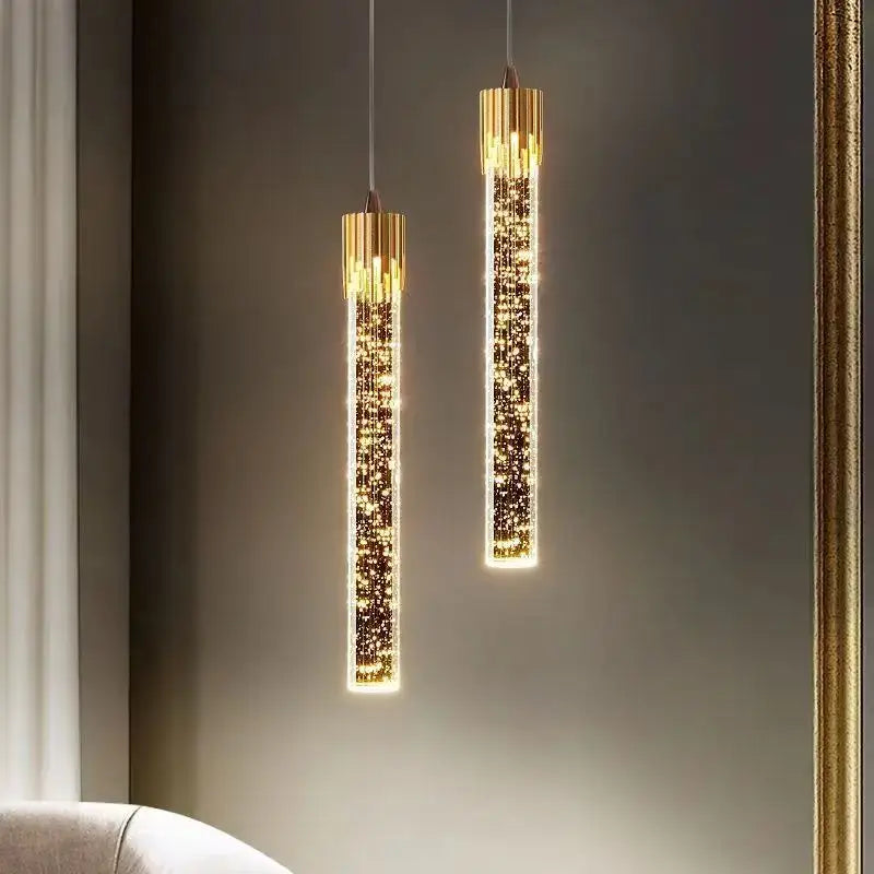 Two elegant gold-toned decorbites bubbles crystal pendant lights with cylindrical glass bodies for living room decor