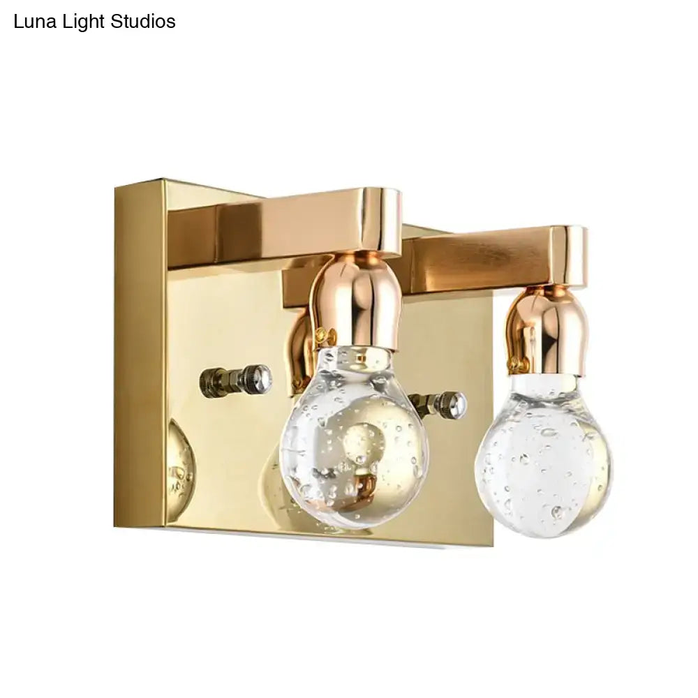 Modern gold bulb shaped crystal wall sconce with clear glass bubble bulbs and brass accents for 110v-120v bedroom lighting
