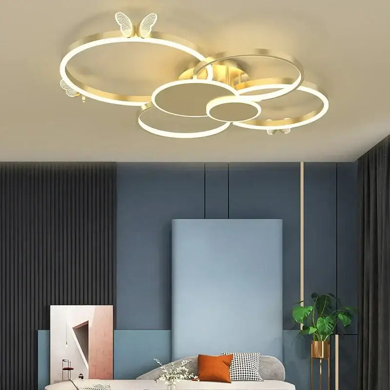 Modern gold butterflies ceiling light with interconnected circular rings and delicate led butterfly accents for bedroom decor