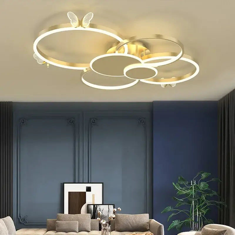 Modern gold butterflies ceiling light features a gold-toned circular led fixture with butterfly accents for bedroom decor
