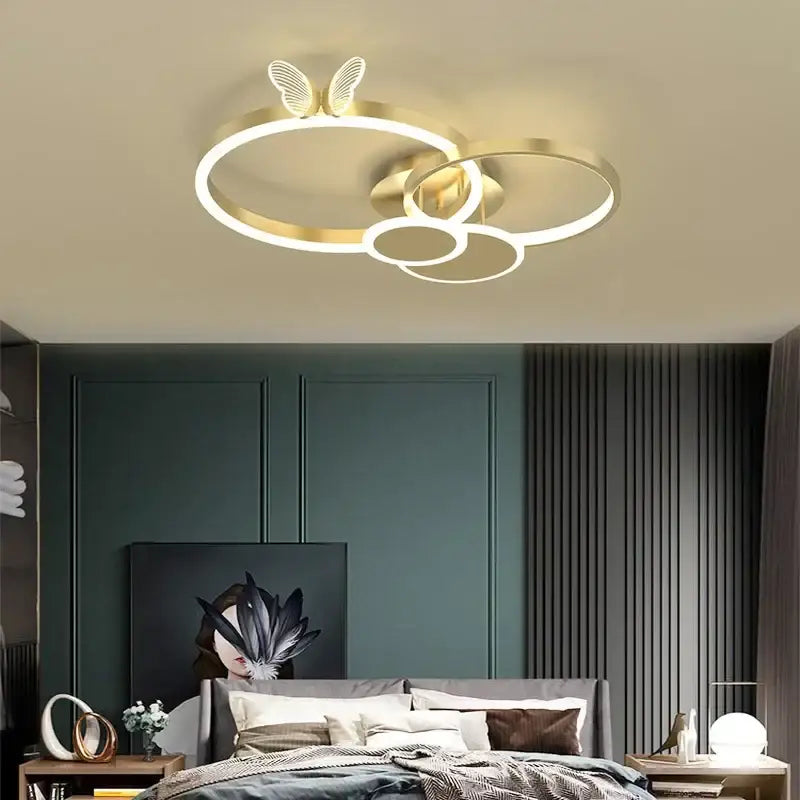 Modern gold butterflies ceiling light featuring gold-toned led interconnected rings with butterfly accent for bedroom decor