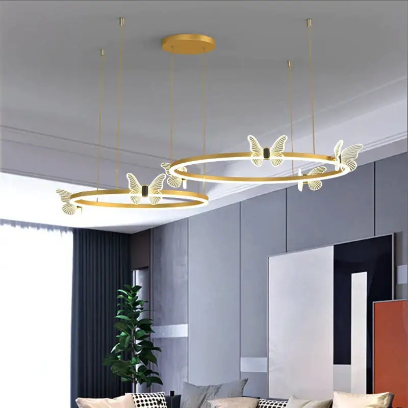 Modern gold butterfly crystal chandelier with illuminated butterfly motifs suspended by thin cords for dining room decorbites butterfly crystal