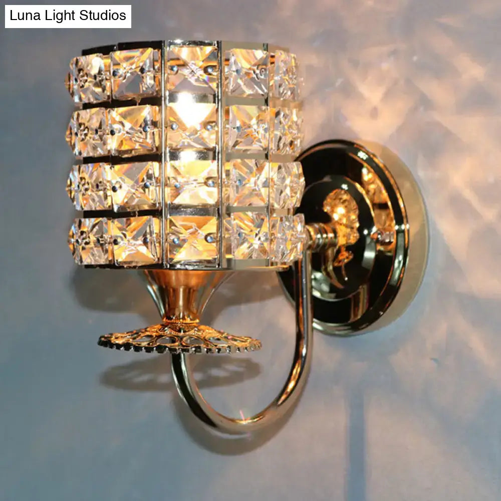 Modern gold butterfly wall light fixture with a crystal shade of clear faceted squares in polished metal for living room