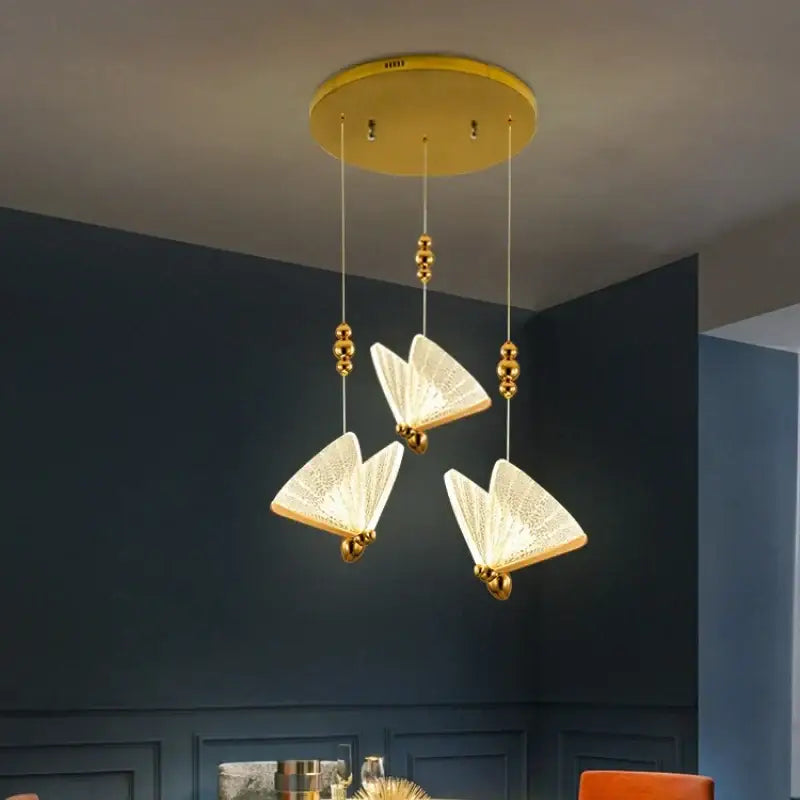 Modern gold butterfly led chandelier with three open-book-shaped etched shades and golden bead cords by decorbites butterfly led