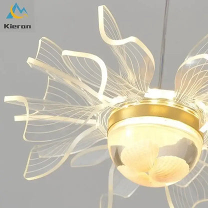 Modern gold butterfly led chandelier featuring a translucent acrylic flower design with warm glowing bulbs for dining room decorbites butterfly led