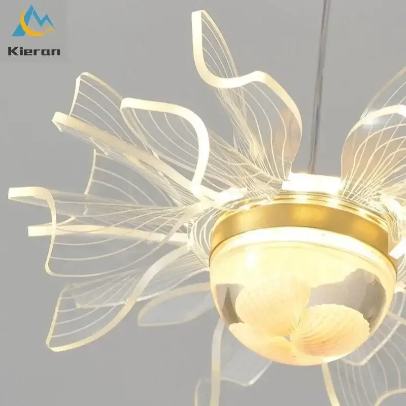 Modern gold butterfly led chandelier featuring a translucent acrylic flower design with warm glowing bulbs for dining room decorbites butterfly led