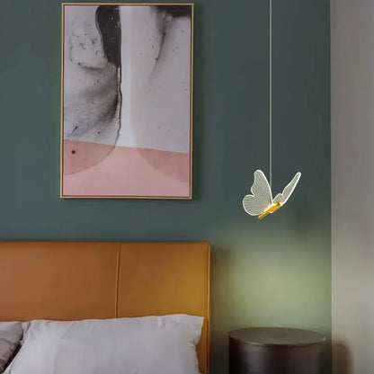 Modern gold butterfly led hanging lamp with translucent glowing wings and golden body for bedroom decorbites butterfly led