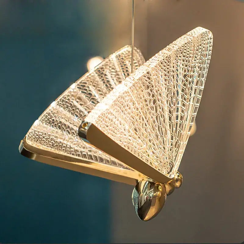 A modern gold butterfly led pendant lamp with intricate crystal mesh wings and polished metallic body for bedroom decorbites butterfly led chandelier lighting