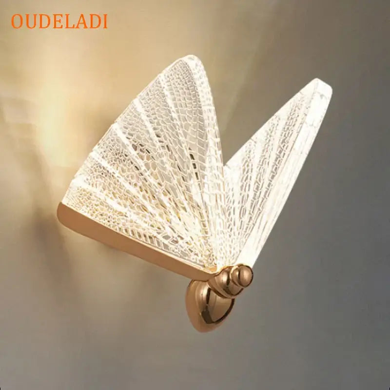 Modern gold butterfly wall lamp with delicate translucent lace detailing and gold-toned metal base for bedroom decorbites butterfly wall lighting
