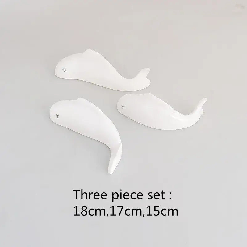 Set of three white ceramic whale figurines with glossy finish and metallic eyes complement decorbites carp fish wall pendant