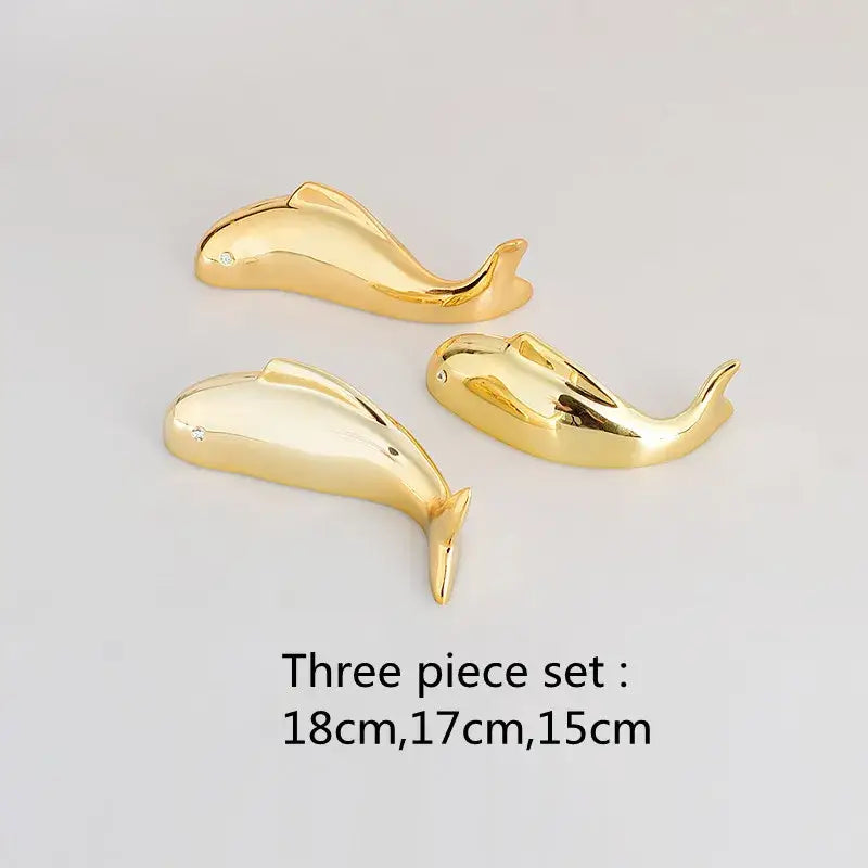 Set of three golden dolphin-shaped wall pendant figurines with polished finish and gemstone eye for decorbites carp fish decor
