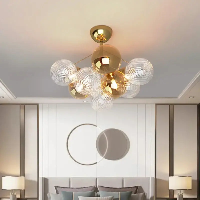 Modern gold cartoon bubble ball chandelier featuring gold-toned spherical glass orbs with polished brass finish for kids room decorbites cartoon bubble