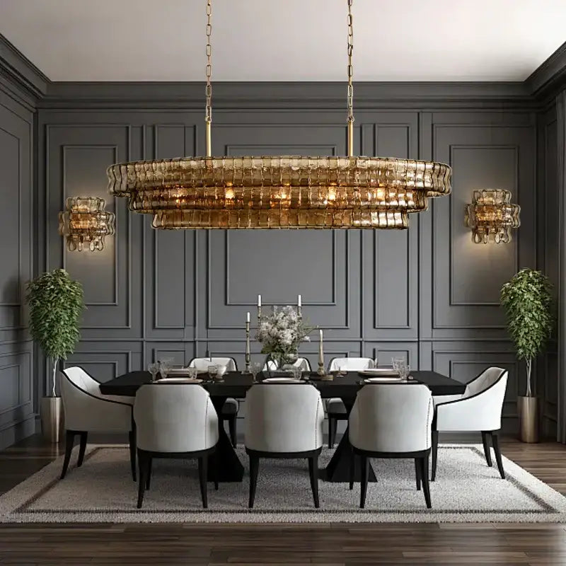 A modern gold multi-tiered cascading pendant light with decorbites brown glass pendant for dining room decor