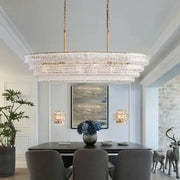 Modern gold cascading crystal pendant lights with clear glass prisms and gold-toned chains for dining room decorbites brown glass