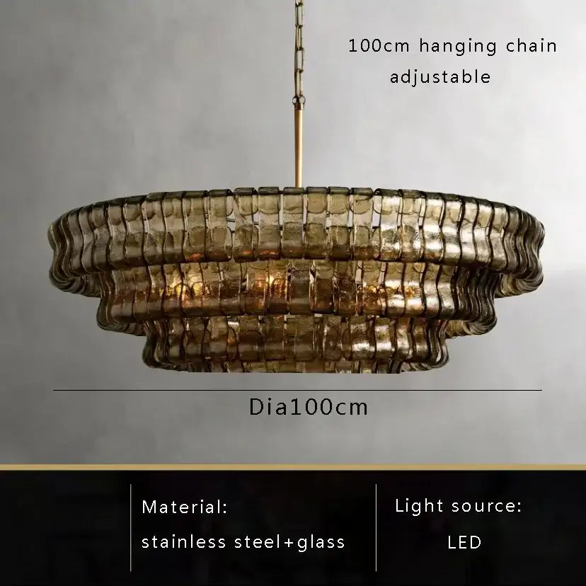 Modern gold cascading crystal pendant lights featuring a tiered amber-tinted brown glass pendant with stainless steel frame