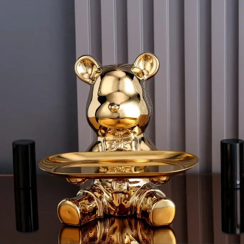 Golden ceramic electroplating bear figurine with glossy finish seated holding an oval tray for modern decor