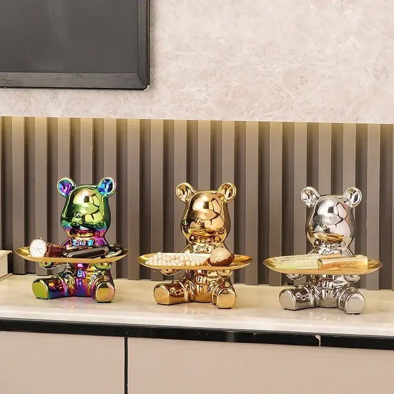 Three glossy gold ceramic electroplating bear figurines each holding a tray with decorative items for living room decor