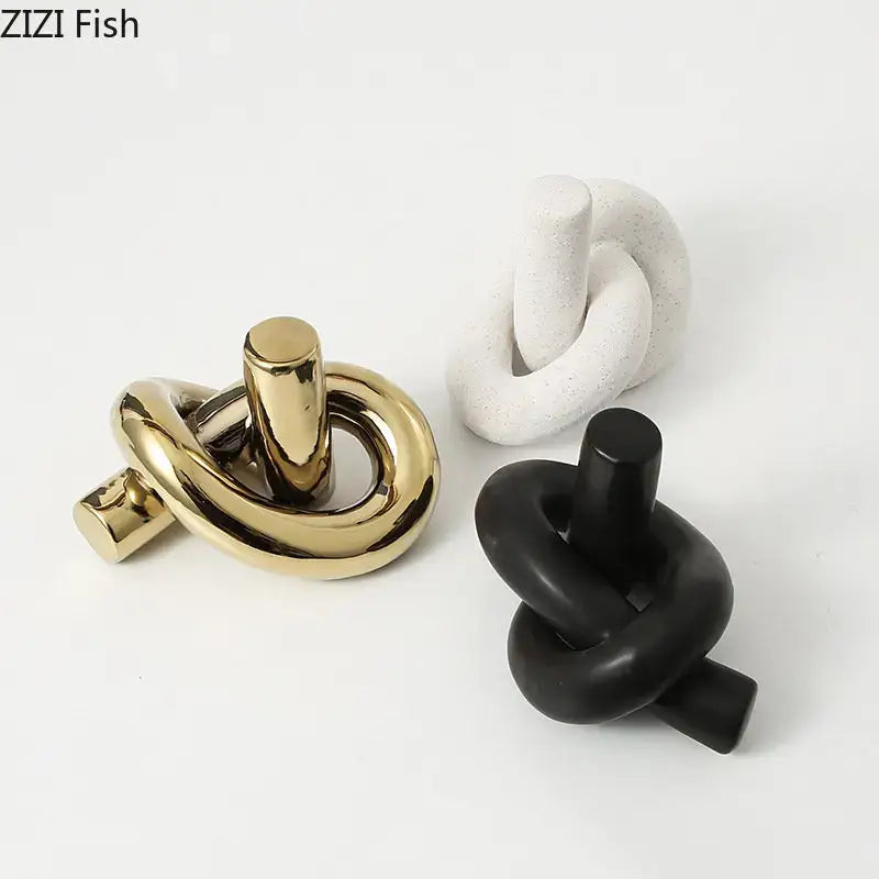 Modern gold ceramic knot sculpture with a glossy finish by decorbites for abstract living room decor