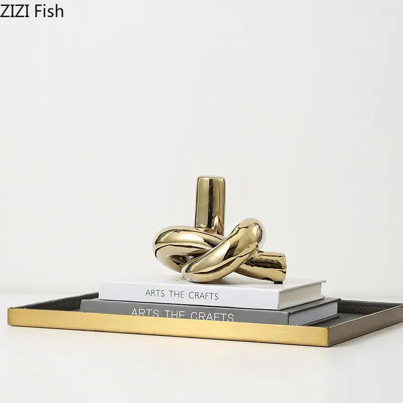 Modern gold ceramic knot sculpture with shiny reflective surfaces for living room decorbites ceramic knot decor