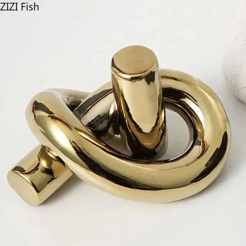 Modern gold ceramic knot sculpture with shiny reflective surfaces for living room decorbites ceramic knot decor