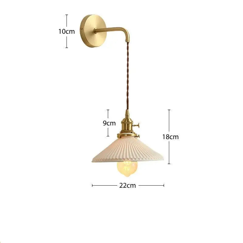Modern gold ceramic wall lamp with a vintage brass sconce, cream ribbed glass shade, and twisted brown cord decorbites ceramic wall lamp