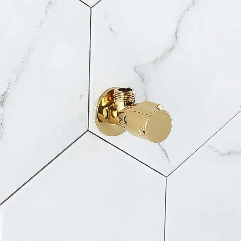 Modern gold and chrome brass triangle valve bathroom water control with decorbites brass triangle on white marble tiles