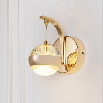 Modern gold chrome wall light with crystal ball featuring crackled glass globe and warm glowing light for bedroom lighting