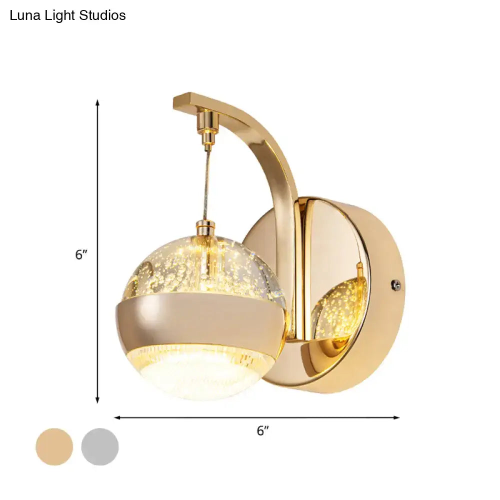 Modern gold and chrome wall light with crystal ball glass globe featuring bubble patterns for bedroom lighting