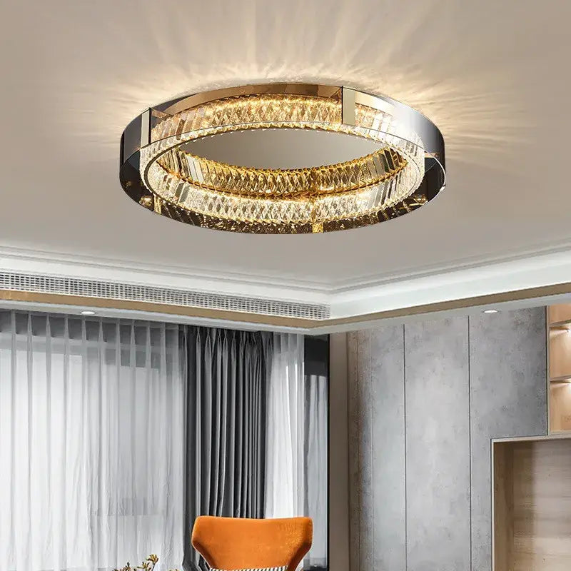 A modern gold and chrome ceiling lamp with two crystal led concentric rings refracting warm light for luxury decorbites decor