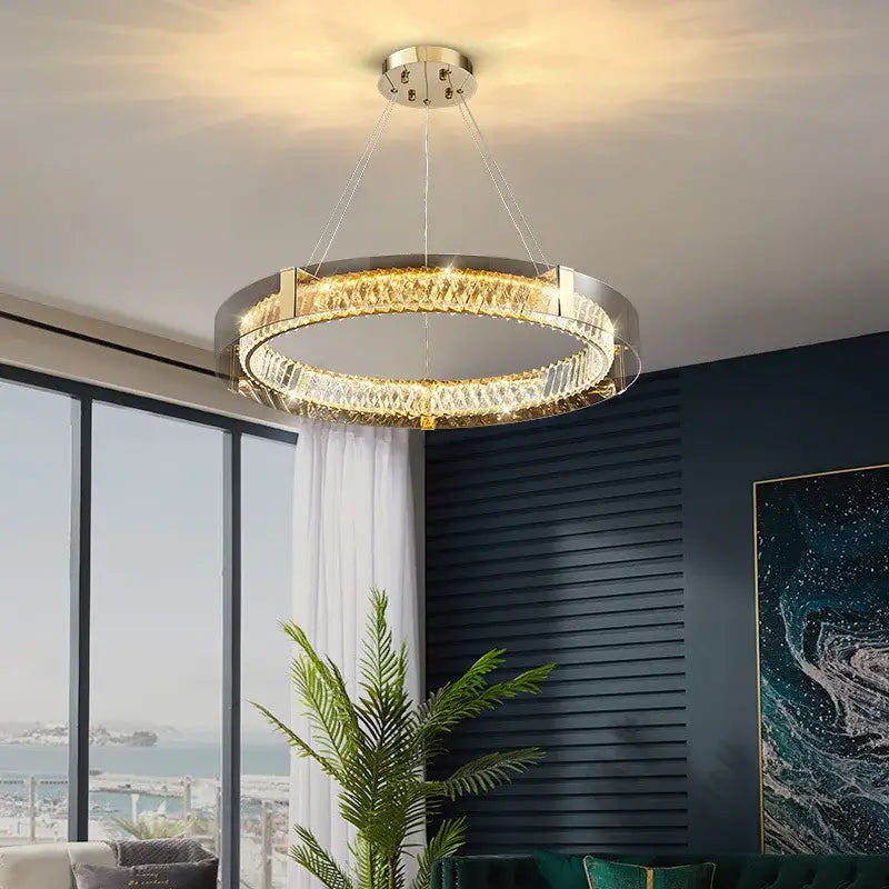 Modern gold and chrome ceiling lamp with sleek metallic frame and decorbites crystal led emitting warm glowing light