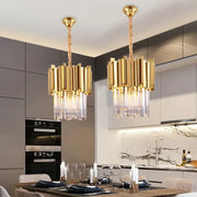 Two modern gold and chrome decorbites crystal pendant chandeliers with vertical bars and hanging crystal droplets for dining room