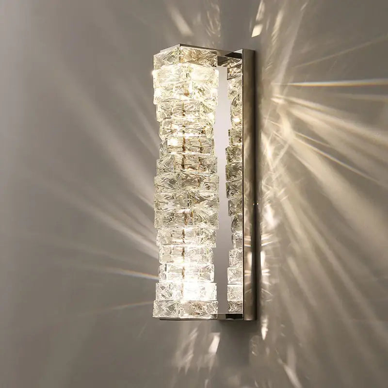 Modern gold and chrome crystal wall lamp with stacked clear blocks emitting geometric light shadows for decorbites crystal wall decor