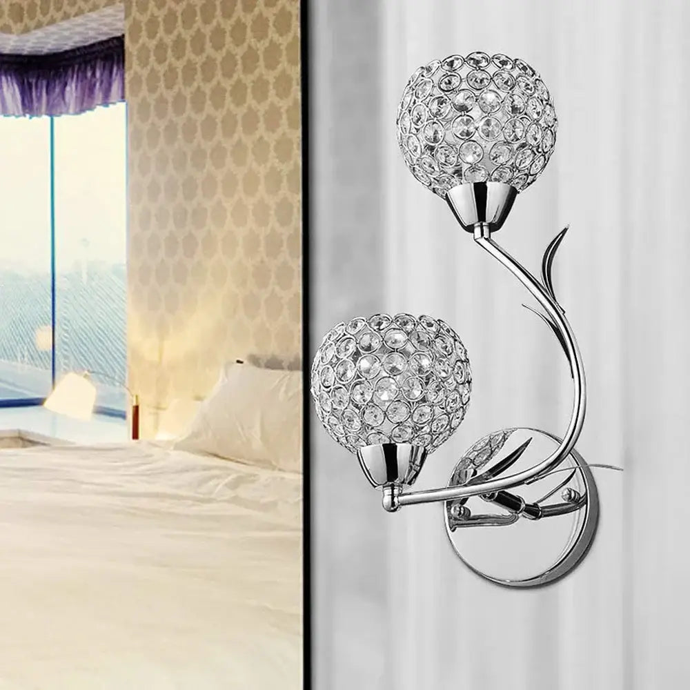 Modern gold and chrome crystal wall sconce with vine-like metal arm and two spherical globes for decorbites crystal wall decor