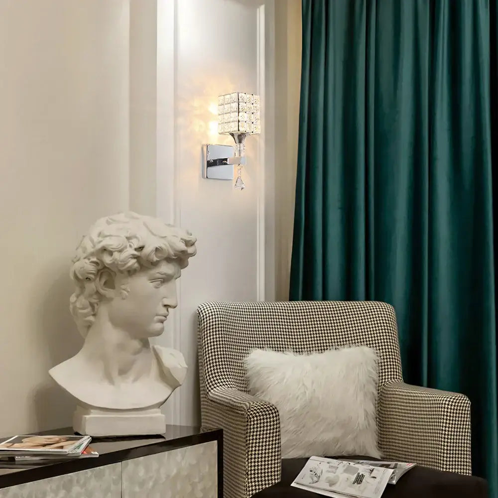 White marble bust of david with detailed curly hair paired with modern gold and chrome crystal wall sconce decorbites crystal wall