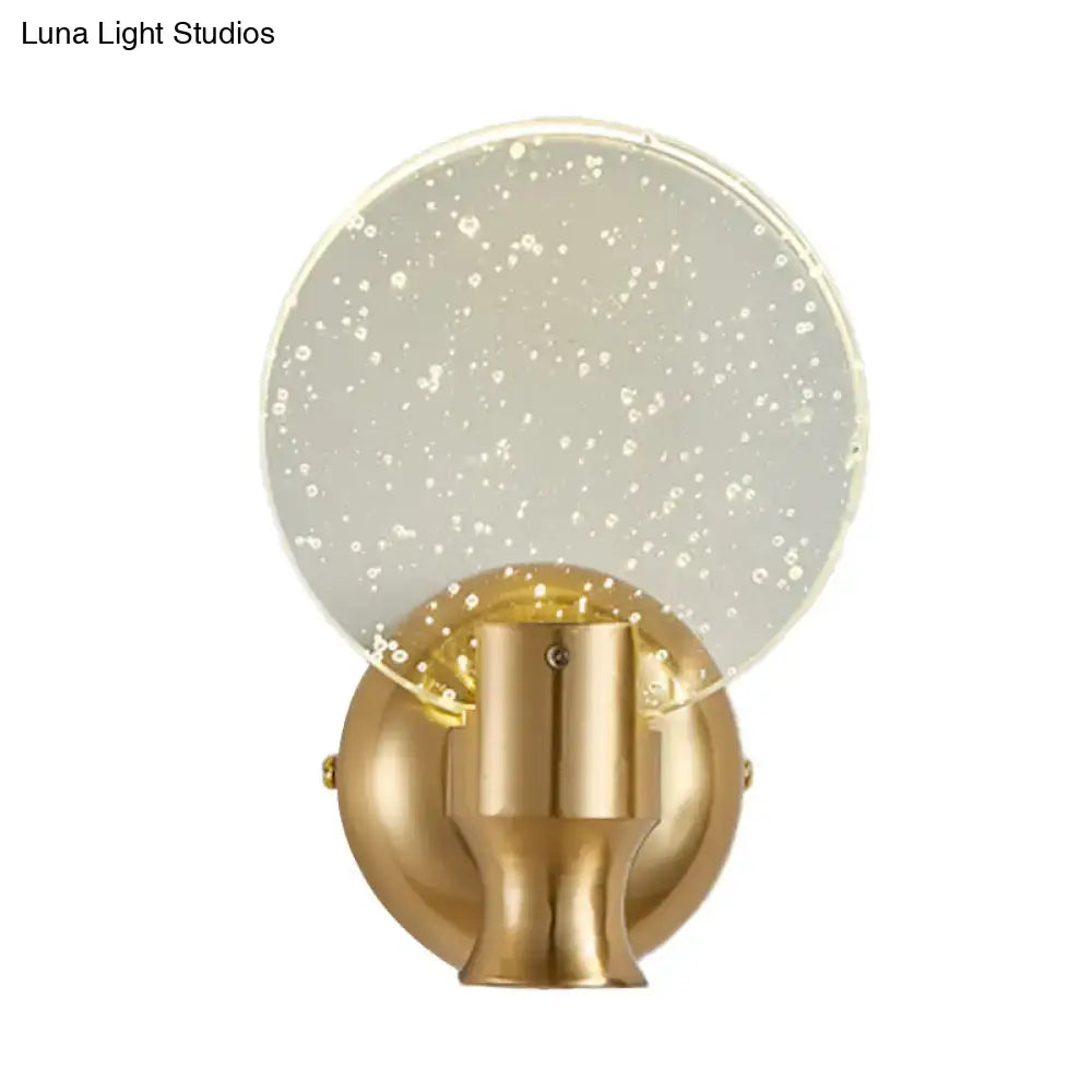 Modern gold circle panel wall light with gold finish and translucent glass shade embedded with white speckles direct wired electric