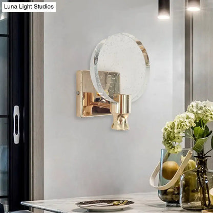 Modern gold circle panel wall light with direct wired electric and speckled translucent glass shade for bedroom use