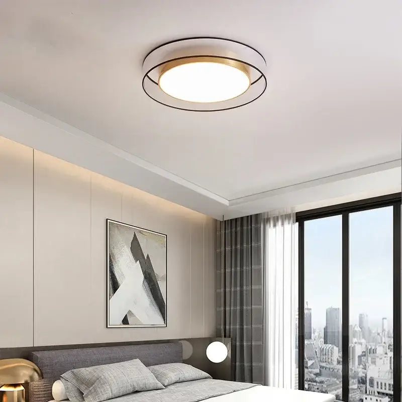 Modern gold circular led ceiling light with a transparent frame featuring a gold center and black outer ring decorbites circular led