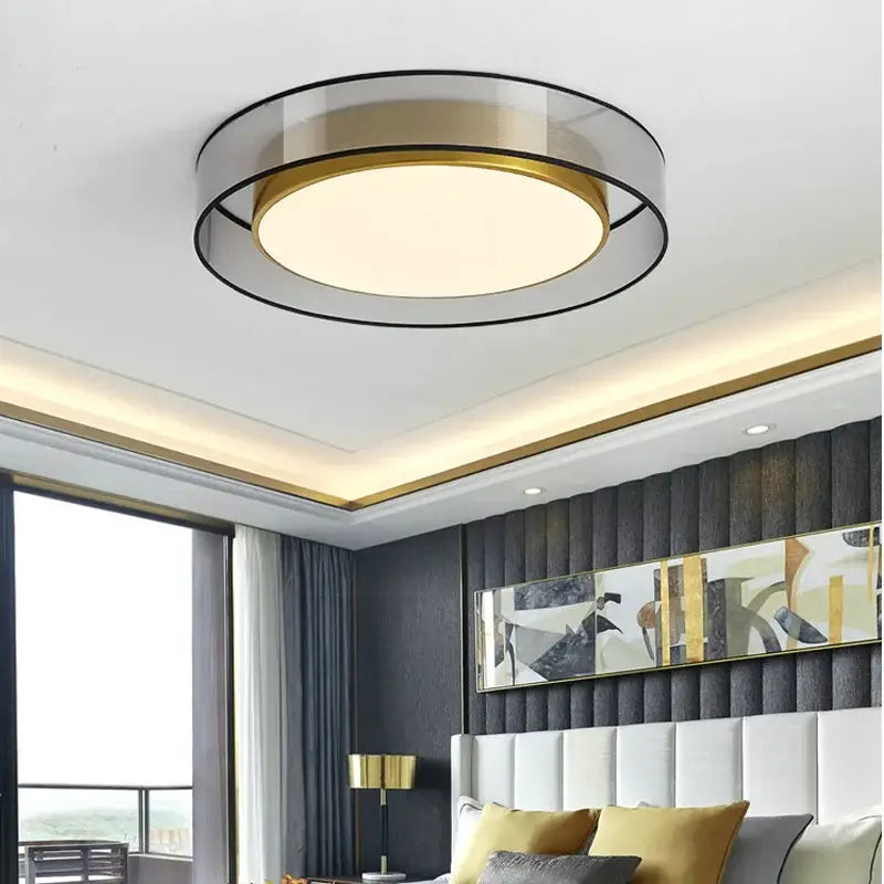 Modern gold circular led ceiling light with a translucent glass diffuser and black metal frame for decorbites circular led decor