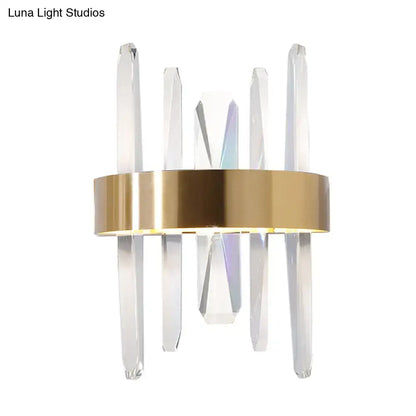 Modern gold wall sconce with clear crystal bar rods and a sleek circular base for bedroom lighting