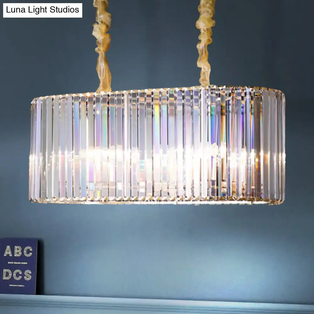 Modern gold clear crystal island chandelier with rectangular vertical rods refracting light for dining room use