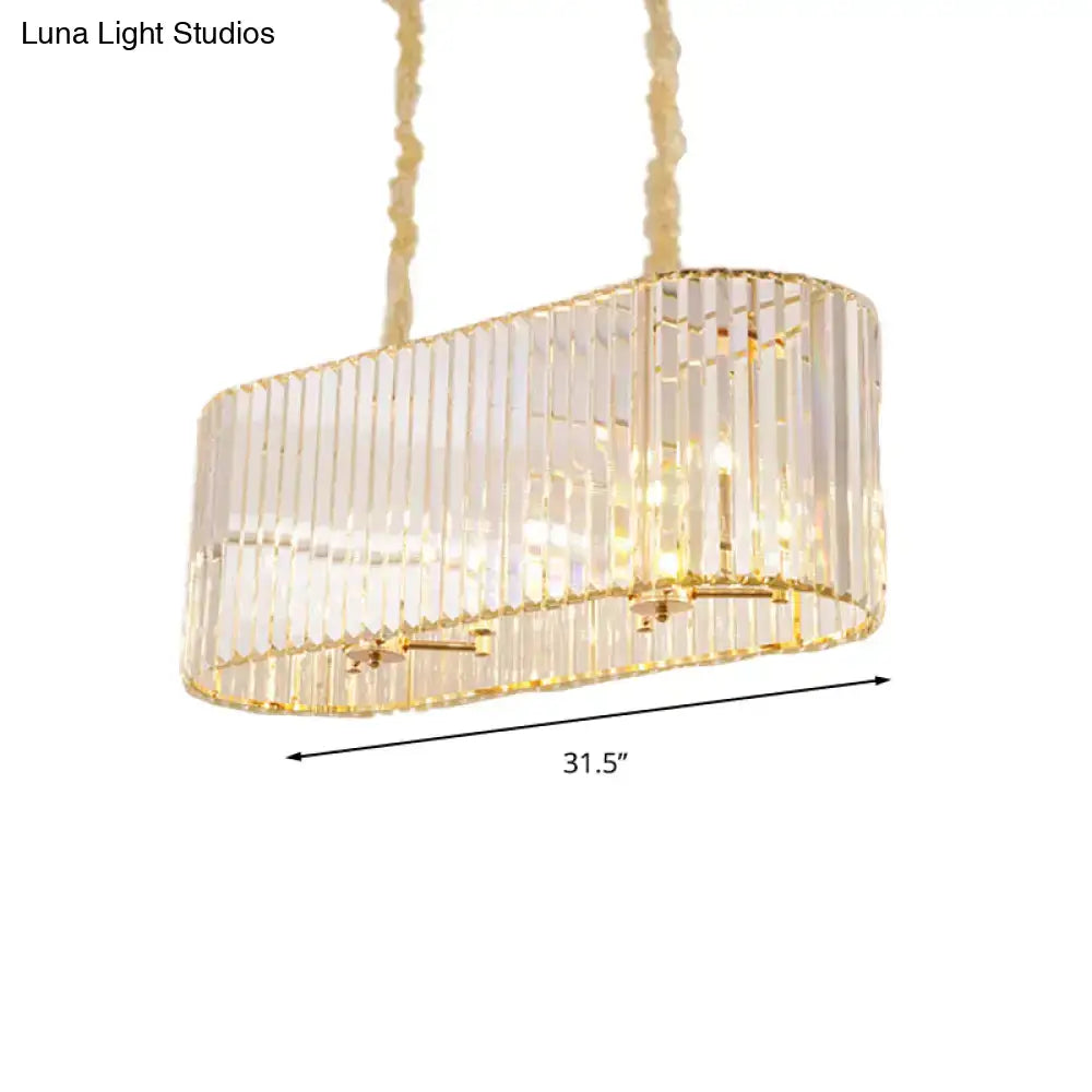 Modern gold clear crystal island chandelier with oval shape, vertical rods, and textured rope suspension for dining room