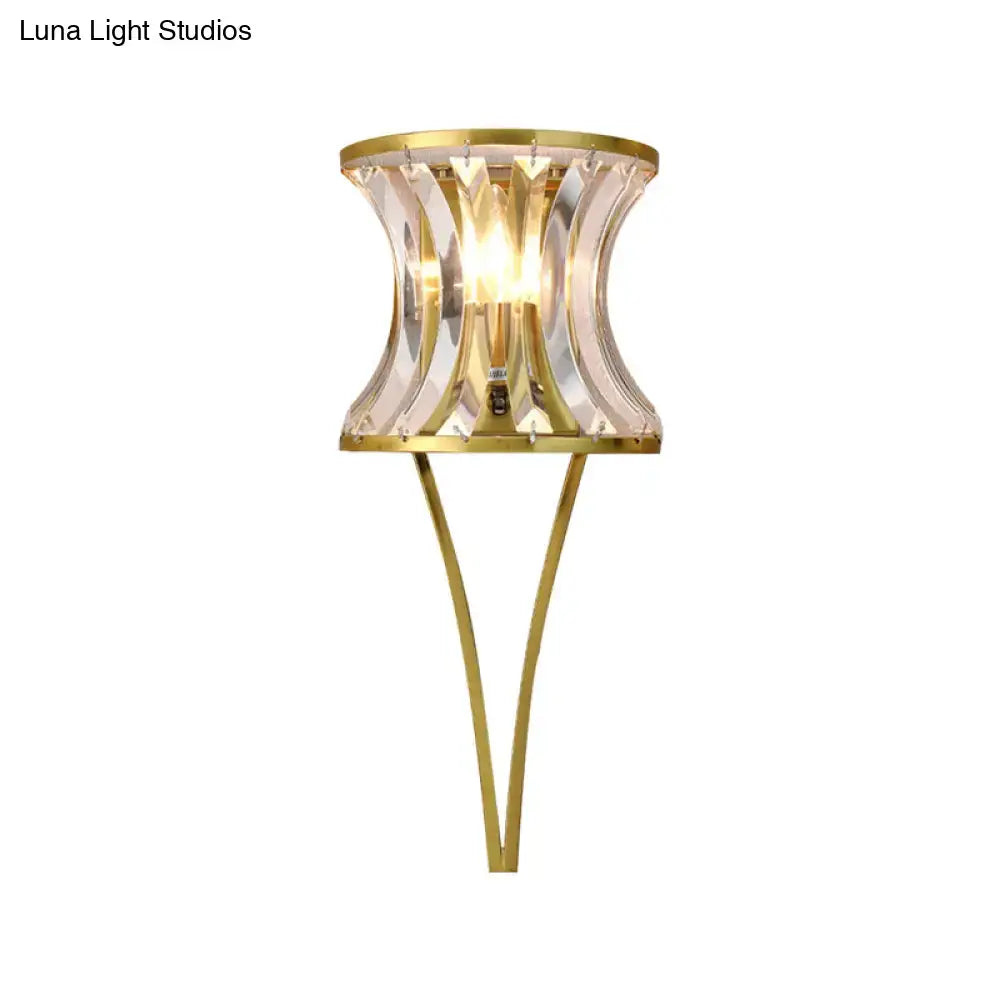 Elegant gold-toned modern wall sconce with a curved clear crystal shade for 110v-120v and 220v-240v living room lighting