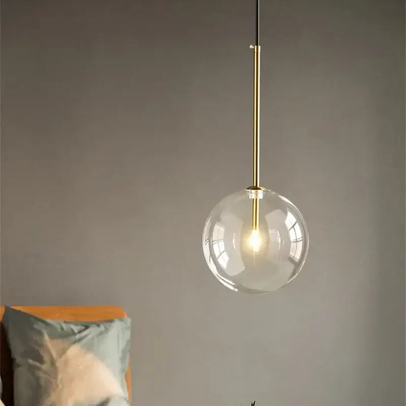 Modern gold clear glass globe pendant light with brass-finished rod perfect for dining room decorbites clear glass pendant light