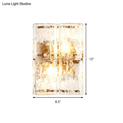Modern gold clear water glass wall sconce with four textured frosted amber water glass shades for bedroom lighting