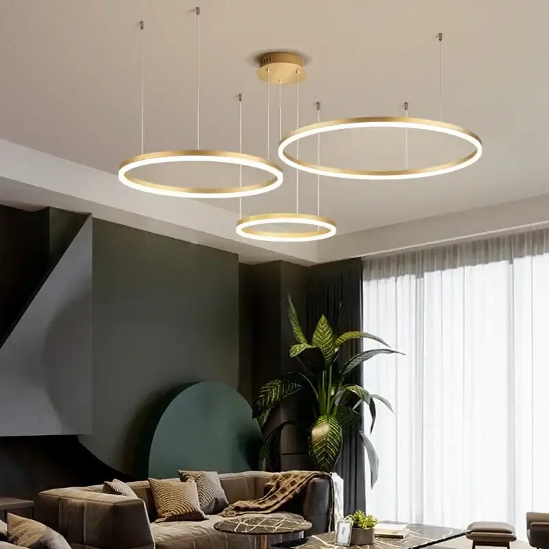 Three modern pendant chandelier brushed rings with gold finish and illuminated led rings for dining room lighting