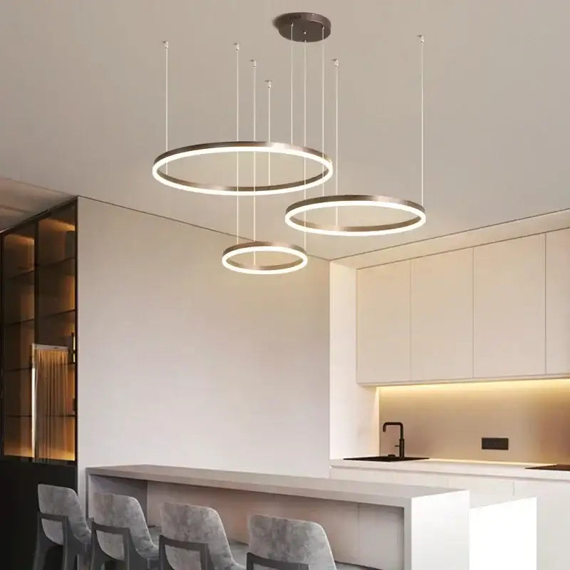 Modern gold and coffee brushed rings pendant chandelier with sleek circular brushed rings and warm led illumination