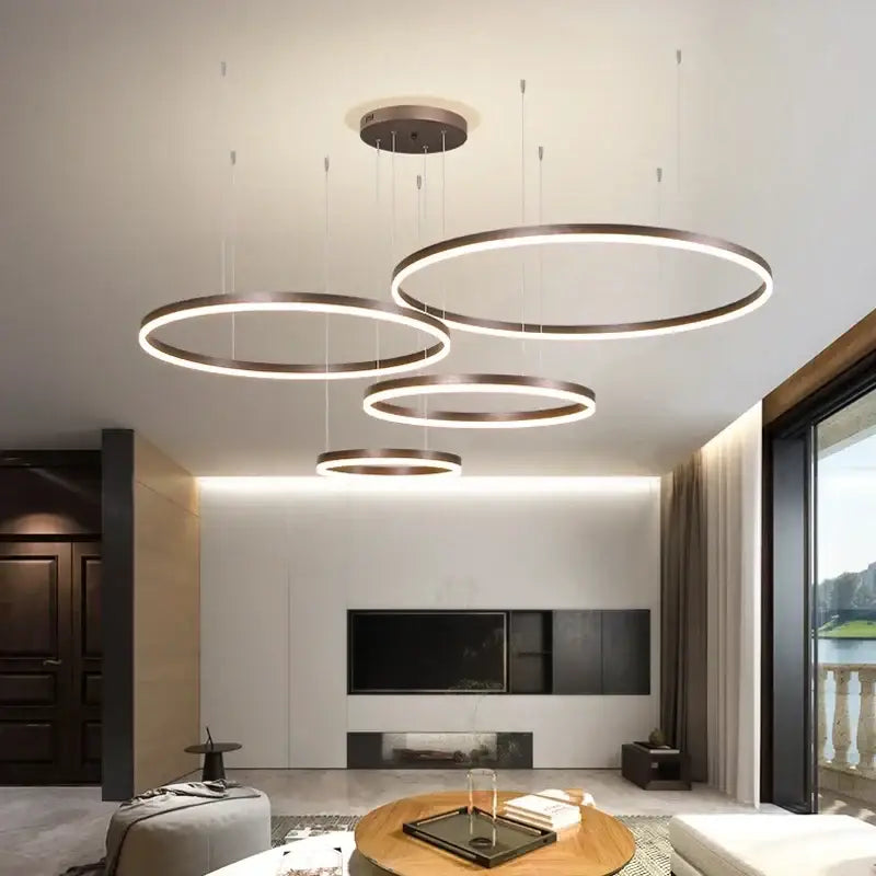Modern gold and coffee brushed rings pendant chandelier featuring sleek metallic frame and glowing led rings for dining room