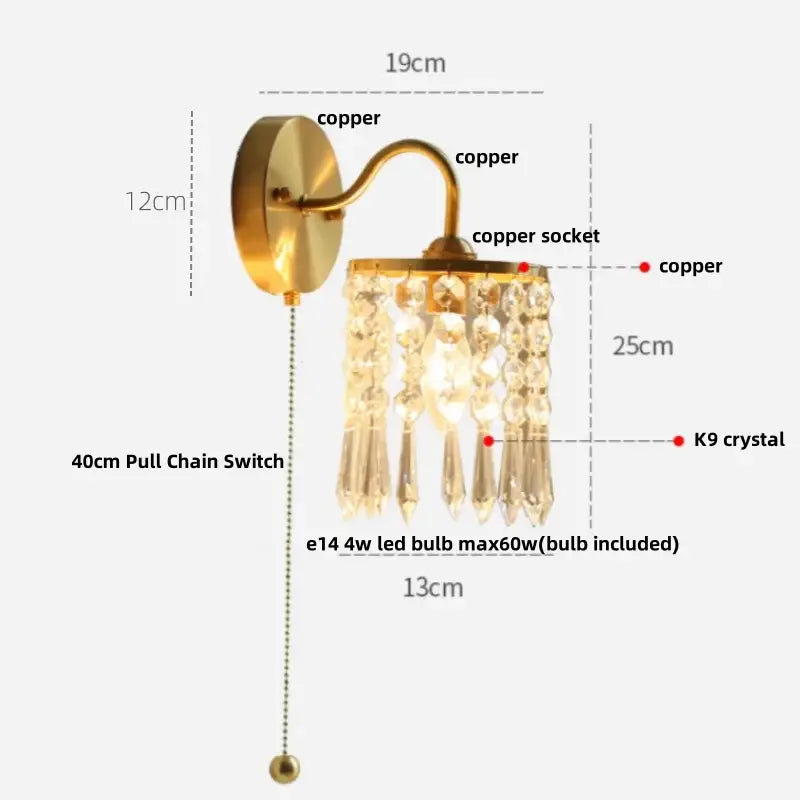 Brass-finished copper wall light fixture with dangling k9 crystal accents and 40cm pull chain switch for bedroom use